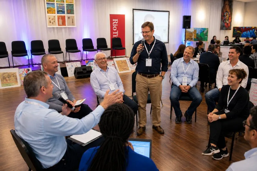 Participants seated in a circle in an office meeting room