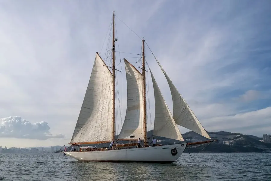 A historic schooner under full sail on open water
