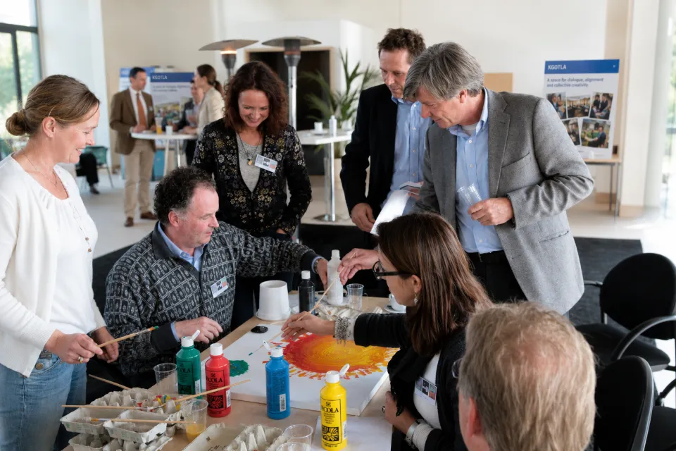 Participants painting together around a table